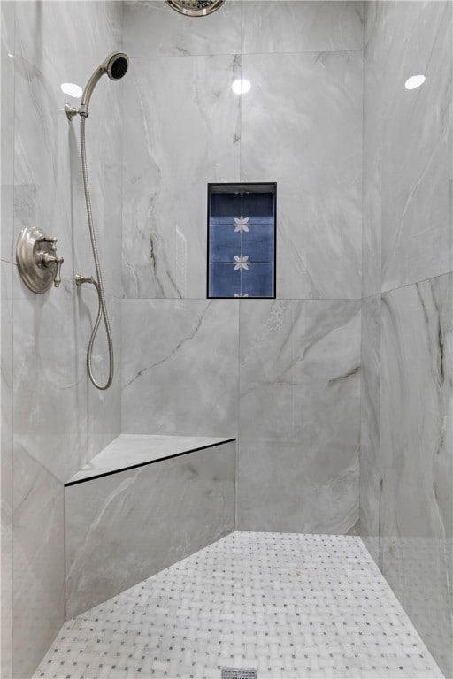 bathroom with a tile shower