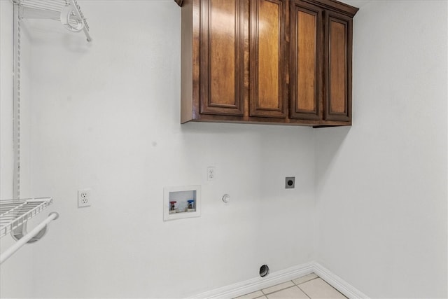 laundry room featuring gas dryer hookup, hookup for a washing machine, light tile patterned floors, cabinets, and electric dryer hookup