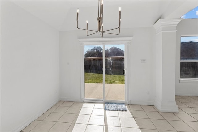 unfurnished dining area featuring light tile patterned flooring and decorative columns