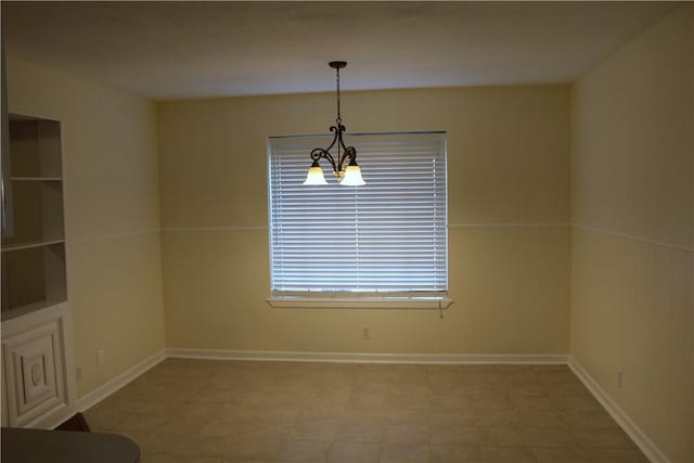 empty room with an inviting chandelier