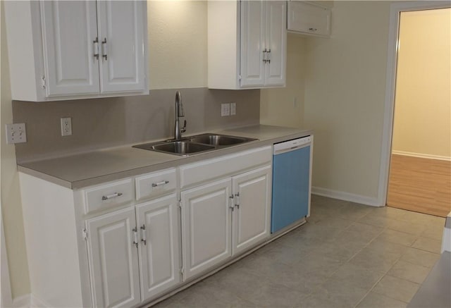 kitchen featuring light tile patterned flooring, sink, white cabinets, and white dishwasher