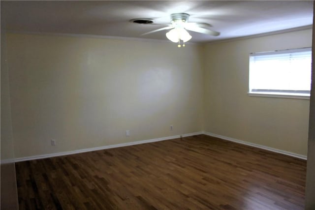 empty room with ornamental molding, dark hardwood / wood-style floors, and ceiling fan