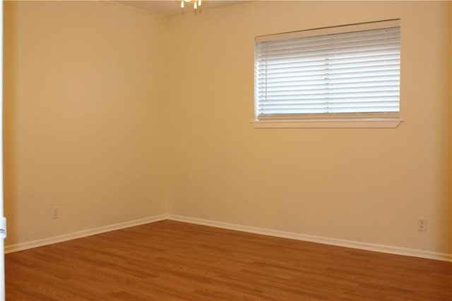 unfurnished room with hardwood / wood-style floors