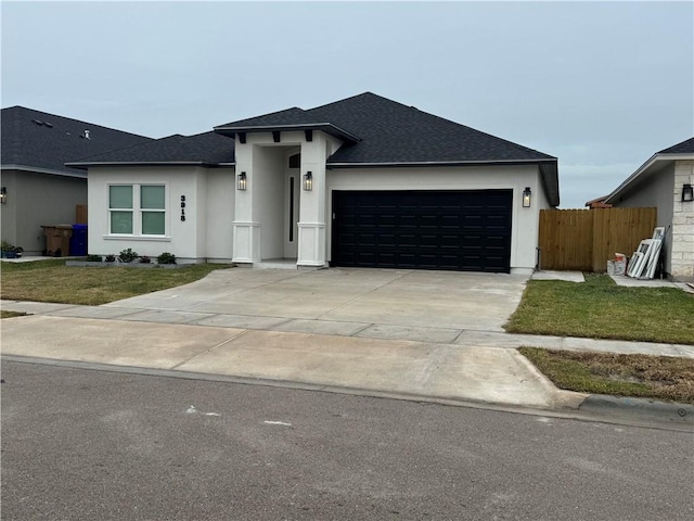 view of front of home featuring a front yard and a garage