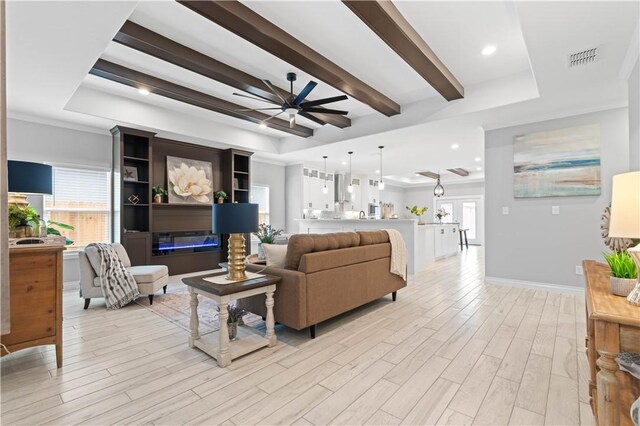 kitchen with white cabinetry, a center island, and wall chimney range hood