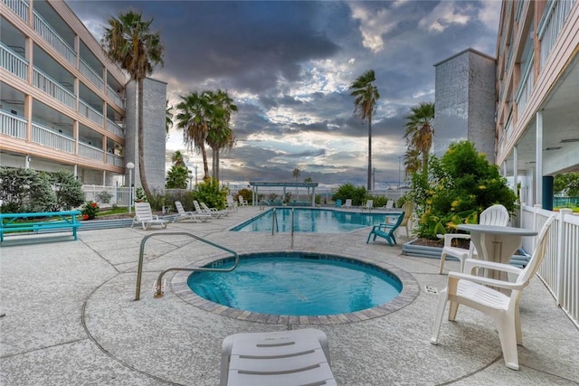 3938 Surfside Blvd Unit 2201, Corpus Christi, TX 78402 - pool at dusk with a hot tub, a patio, and a community pool
