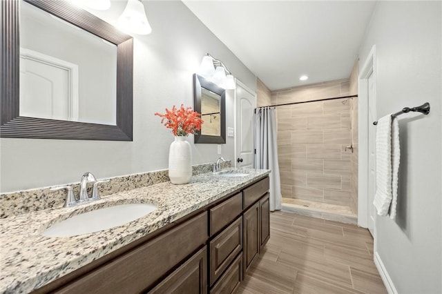 7209 Lake Tranquility Dr, Corpus Christi, TX 78414 - bathroom with tiled shower, double vanity, and recessed lighting