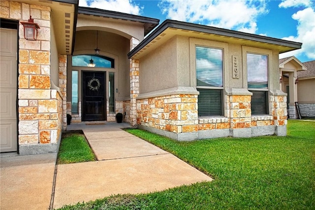 7209 Lake Tranquility Dr, Corpus Christi, TX 78414 - property entrance featuring stone siding, a lawn, and stucco siding