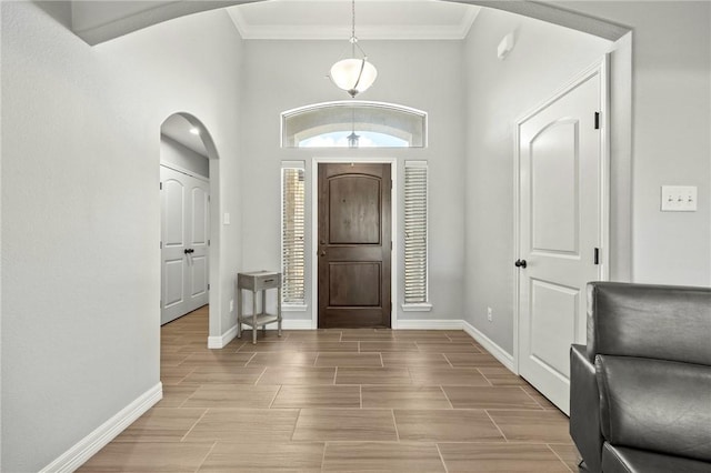 7209 Lake Tranquility Dr, Corpus Christi, TX 78414 - entryway featuring arched walkways, crown molding, wood finish floors, and a high ceiling