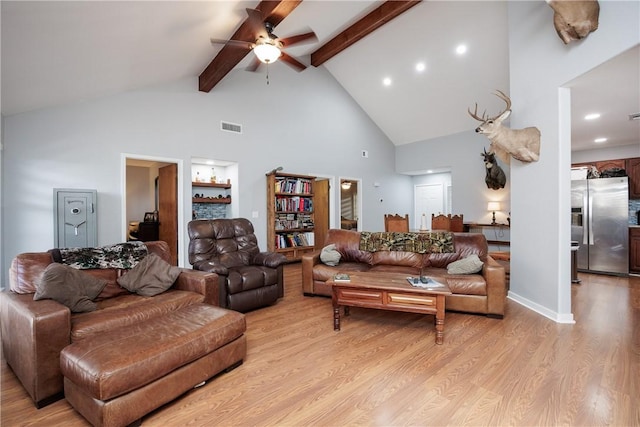 living room with ceiling fan, beamed ceiling, high vaulted ceiling, and light wood-type flooring