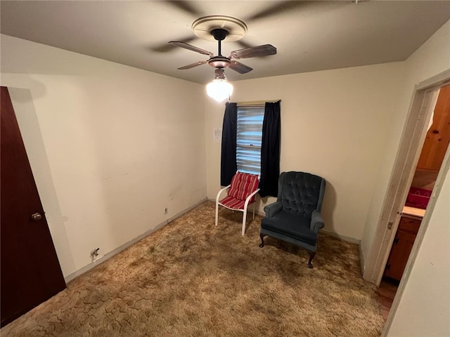 living area featuring carpet flooring and ceiling fan