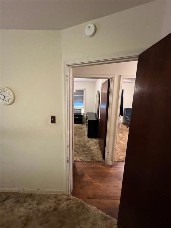 hallway featuring dark hardwood / wood-style flooring