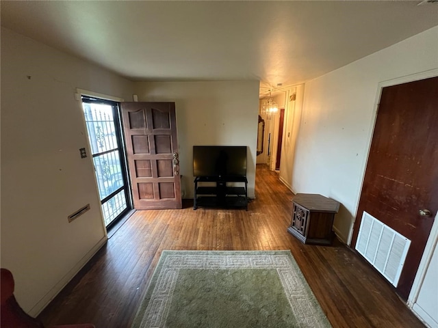 unfurnished living room with dark hardwood / wood-style flooring