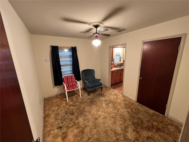 sitting room with light colored carpet and ceiling fan