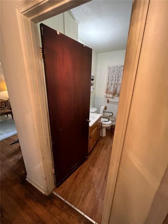 bathroom featuring hardwood / wood-style floors, vanity, and toilet