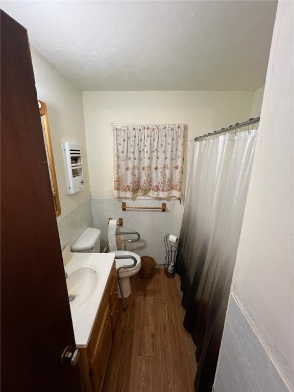 bathroom featuring hardwood / wood-style flooring, vanity, toilet, and tile walls