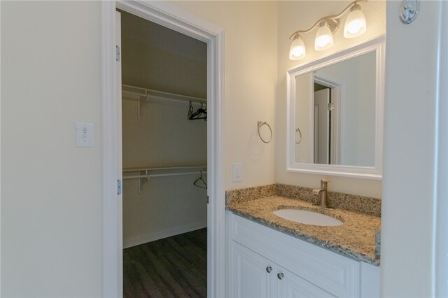 bathroom with hardwood / wood-style floors and vanity