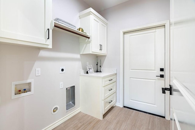 laundry area featuring cabinet space, baseboards, light wood-style flooring, hookup for an electric dryer, and washer hookup