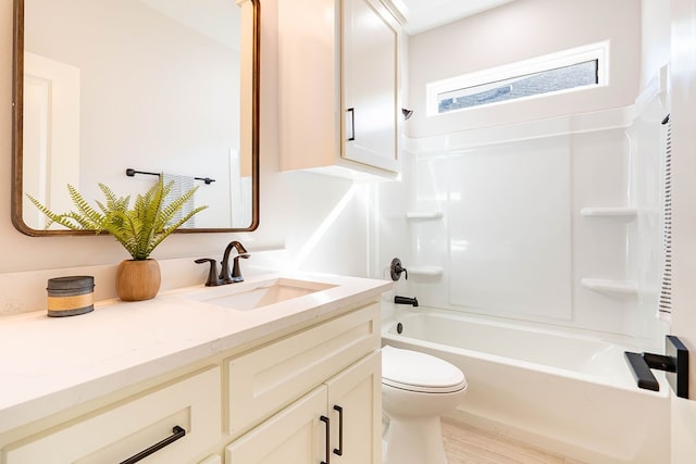 bathroom with tub / shower combination, vanity, and toilet