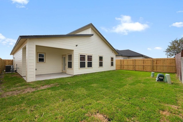 back of house featuring a yard, a patio, cooling unit, and a fenced backyard