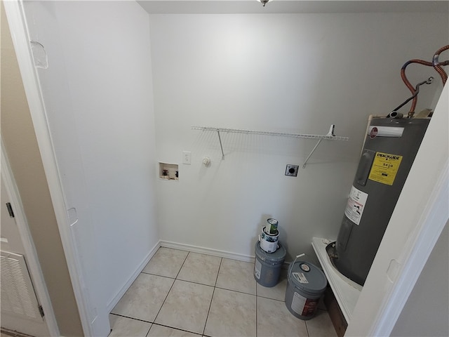 laundry room with electric water heater, electric dryer hookup, light tile patterned floors, and washer hookup