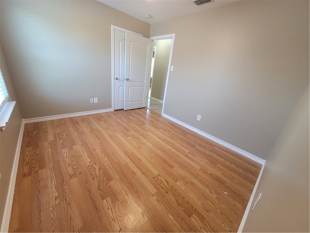 unfurnished room with light hardwood / wood-style flooring