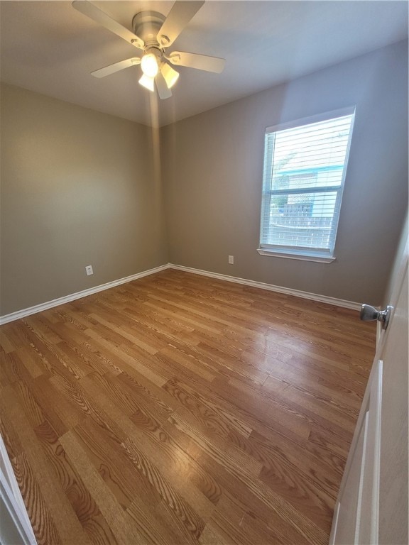 spare room featuring ceiling fan and light wood-type flooring