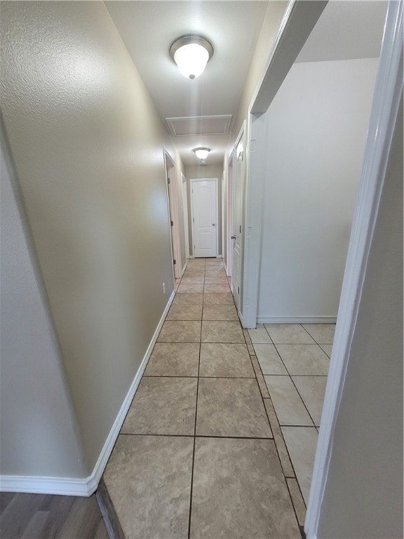 hall featuring light tile patterned floors