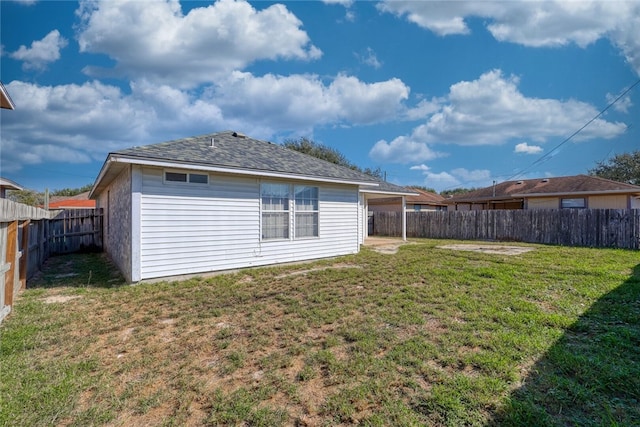 rear view of property with a lawn