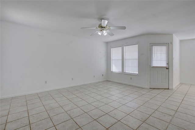 unfurnished room with ceiling fan and light tile patterned flooring