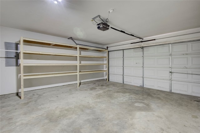 garage featuring electric panel and a garage door opener