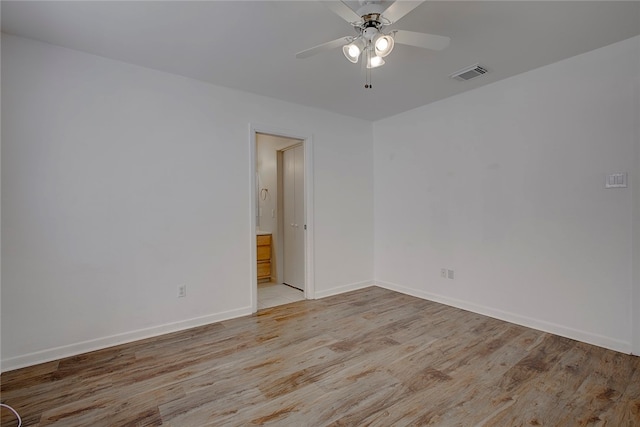 empty room featuring ceiling fan and light wood-type flooring