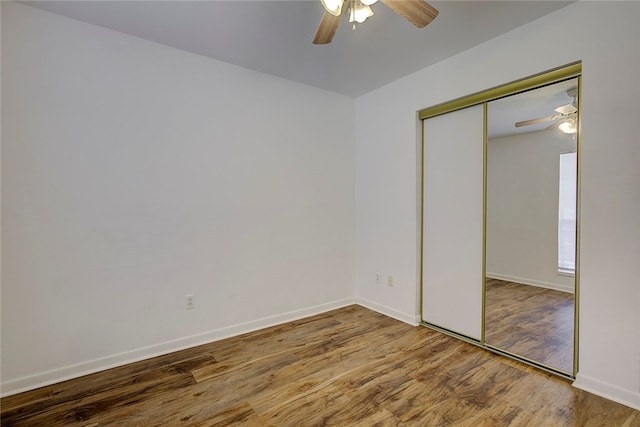 unfurnished bedroom with a closet, ceiling fan, and hardwood / wood-style floors