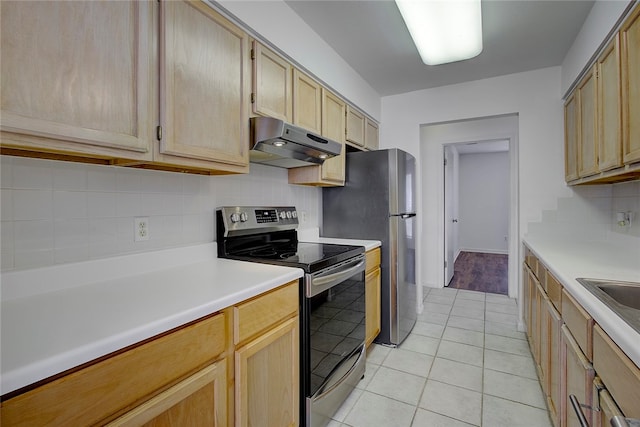 kitchen featuring light brown cabinetry, electric range, light tile patterned floors, and backsplash