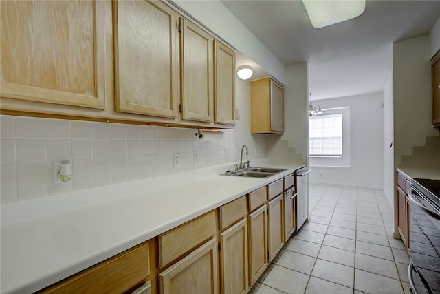 kitchen featuring sink, light brown cabinets, stainless steel appliances, tasteful backsplash, and light tile patterned flooring