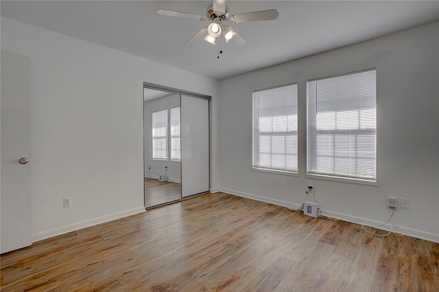 unfurnished room featuring plenty of natural light, ceiling fan, and light wood-type flooring