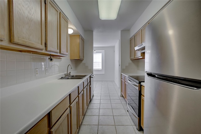 kitchen with appliances with stainless steel finishes, light brown cabinets, light tile patterned floors, and sink