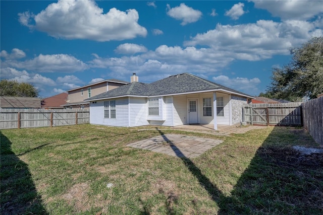 rear view of house with a lawn and a patio area