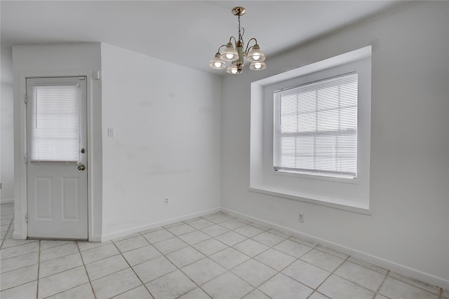 unfurnished dining area with light tile patterned floors and an inviting chandelier