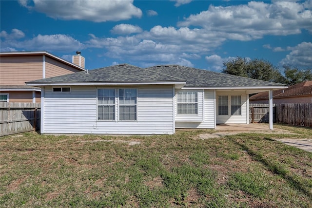 back of property featuring a patio area and a lawn