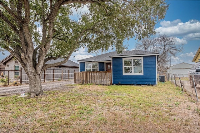 bungalow-style house with fence private yard, a front yard, and central air condition unit