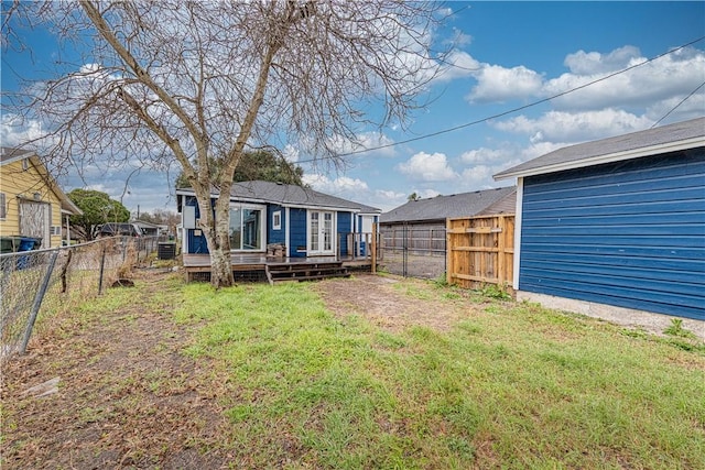 view of yard featuring a fenced backyard and a deck