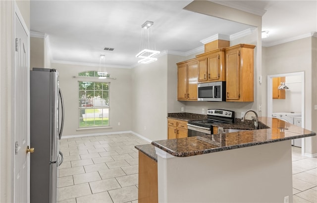 3613 Berkeley Dr, Corpus Christi, TX 78414 - kitchen with stainless steel appliances, light tile patterned floors, a peninsula, dark stone counters, and crown molding