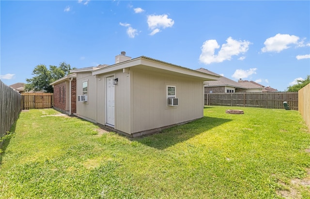 3613 Berkeley Dr, Corpus Christi, TX 78414 - back of property with a chimney, a fenced backyard, cooling unit, and a fire pit