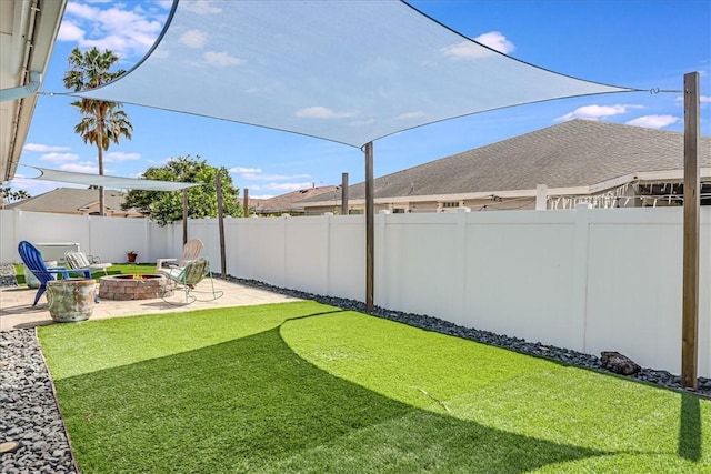 view of yard with an outdoor fire pit and a patio