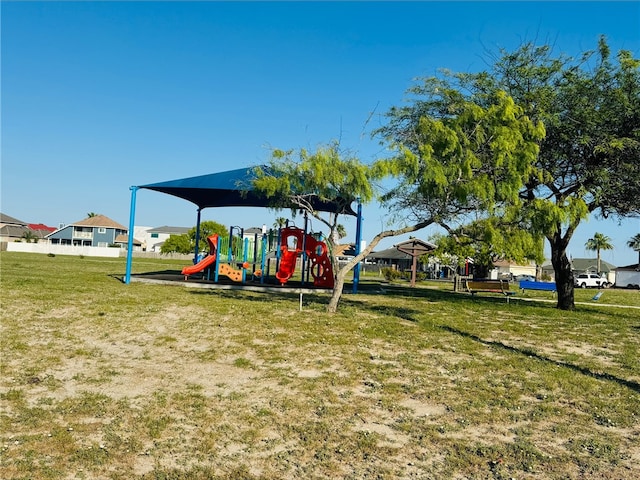community jungle gym featuring a yard