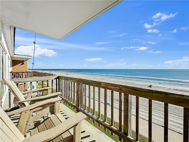 balcony with a view of the beach and a water view