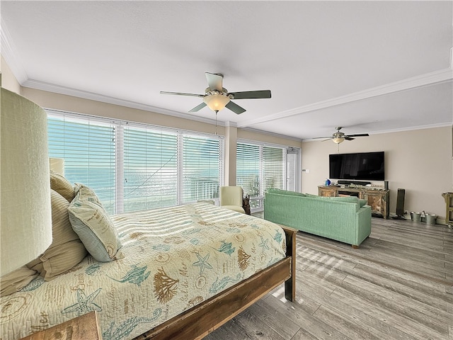 bedroom with ceiling fan, hardwood / wood-style floors, and crown molding