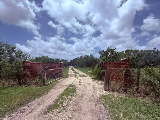 5742 Hidden Valley Loop, Sandia, TX 78383 - view of dirt / gravel driveway featuring a gated entry