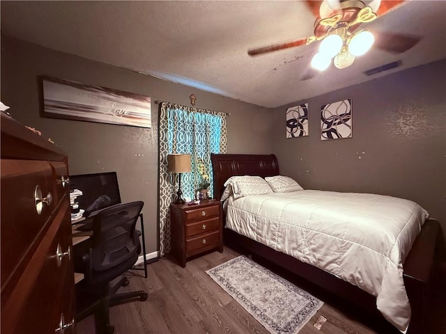 5742 Hidden Valley Loop, Sandia, TX 78383 - bedroom with wood finished floors, an office area, a textured ceiling, and a ceiling fan